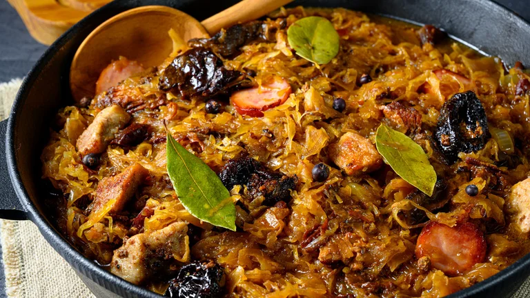 Polish traditional cabbage dish with sausage, spices, and bay leaves.