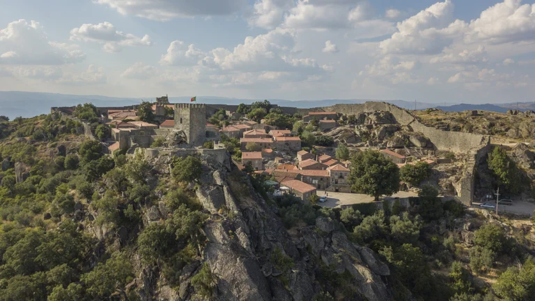 Hilltop stone village of Sortelha surrounded by rocky landscape in Portugal