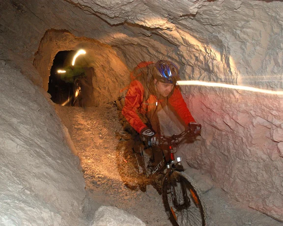 A man biking underground of the cave.
