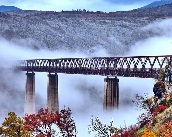 Get that special photo of rolling into the fog as your cross Montenegro's highest railway bridge.