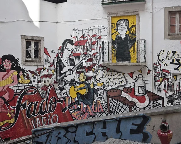 Smile at the wild Fado street art in Escadinhas de São Critovão in Lisbon.