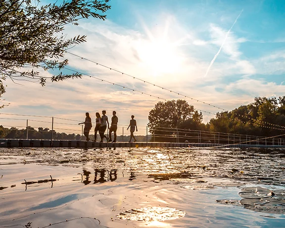 Cross the bridge over the lake at sunset, all part of your INMusic Festival experience in Zagreb.