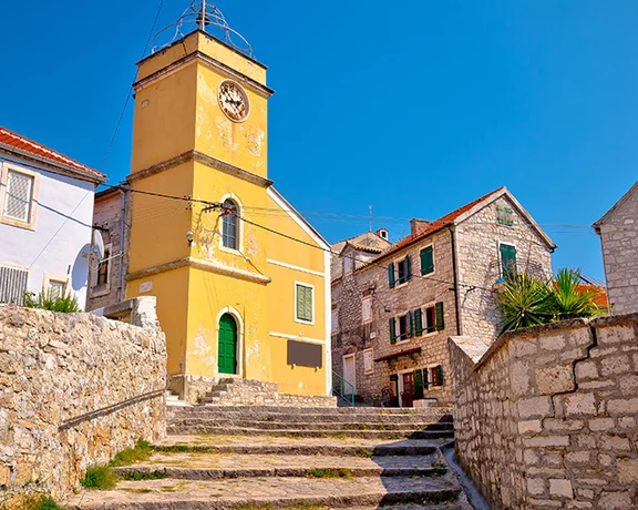 Take in colorful buildings in the old city center of Zlarin.