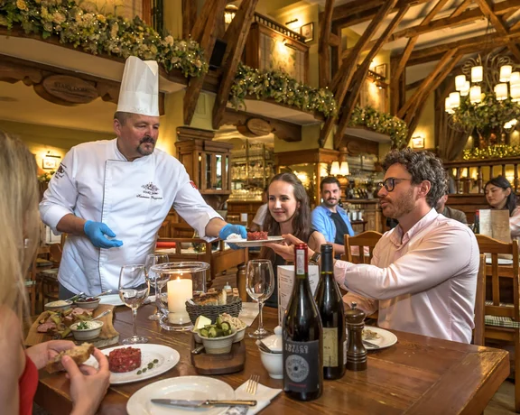Traditional food experience in Warsaw with a table, wine and a cozy ambiance.