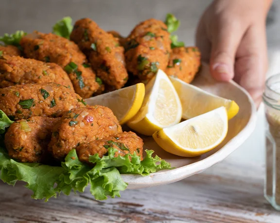 Delight in crunch, tang, and spice with a dish of lentil köfte (Mercimek Köftesi).