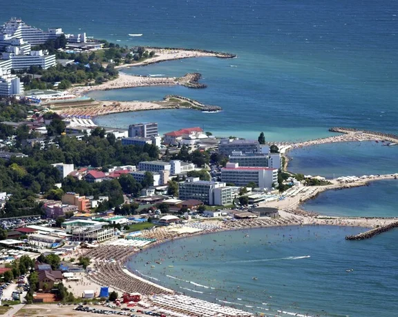 Aerial view of a coastal resort city with beaches, hotels, and breakwaters at the Black Sea, in te Romanian Coast.