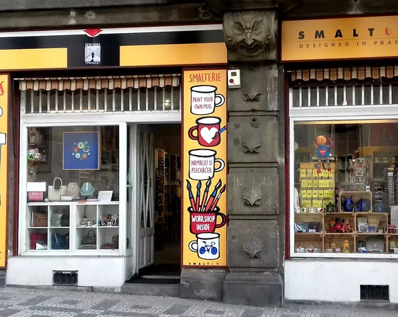 Exterior of a gift shop in Prague, featuring a workshop for painting mugs.