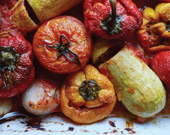 A classic Cypriot dish, gemista, featuring vegetables such as tomatoes, peppers, zuchinni and onions stuffed with a savory rice and herb mixture.