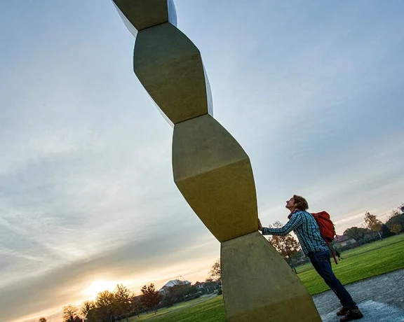 Men watching a statue.