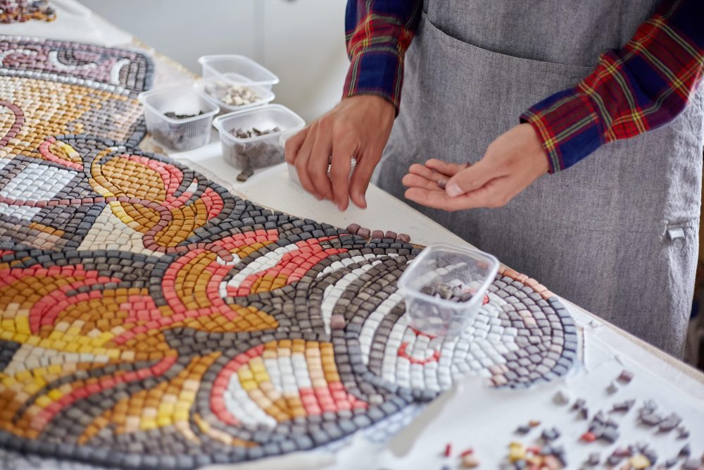 Assembling of small mosaic pieces to form the bigger picture. 