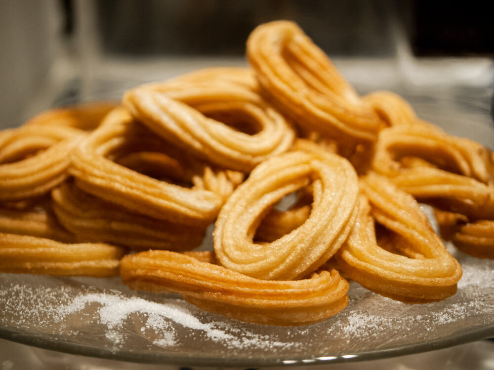 A close-up of churros dusted with sugar.