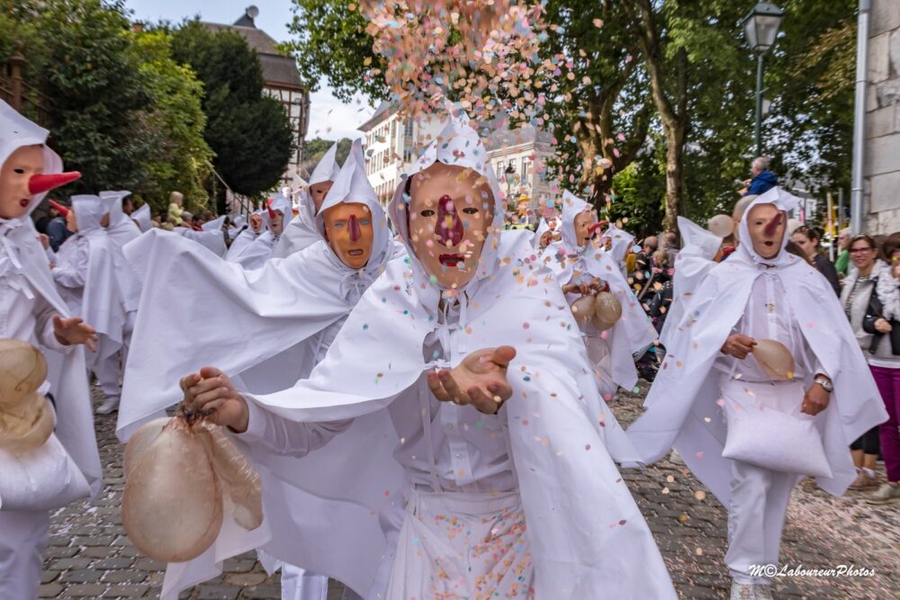Catch some confetti from the Blanc Moussis at Carnival Stavelot, Belgium