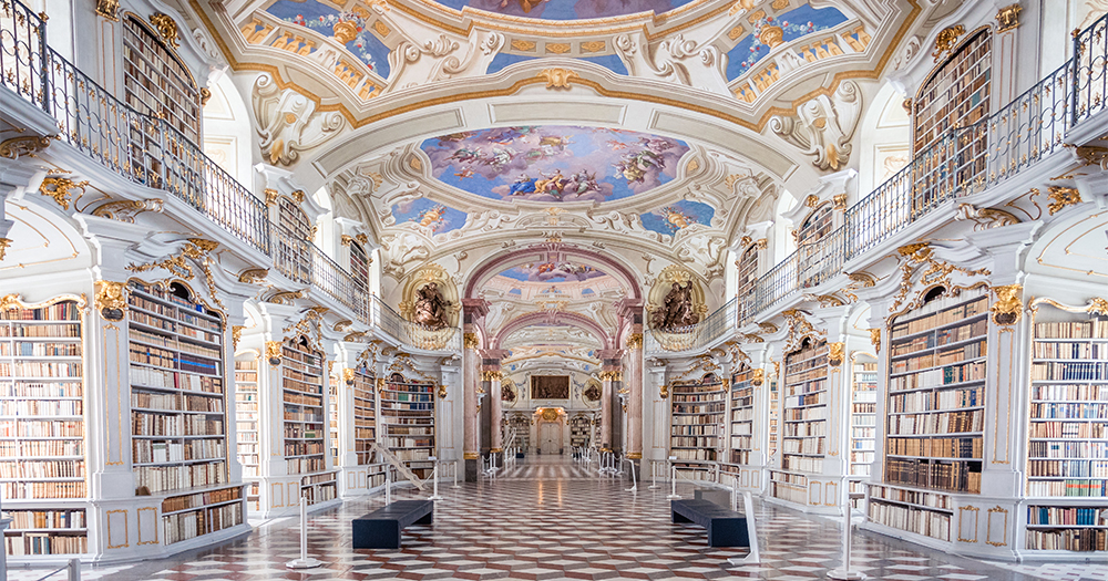 Inside Admont Abbey library in Styria, Austria, with beautifully decorated Baroque ceilings and shelves full of historic books