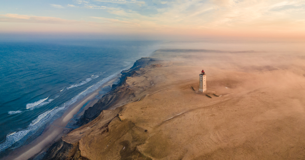 Breathe in clean coastal scenery at Rubjerg Knude Lighthouse