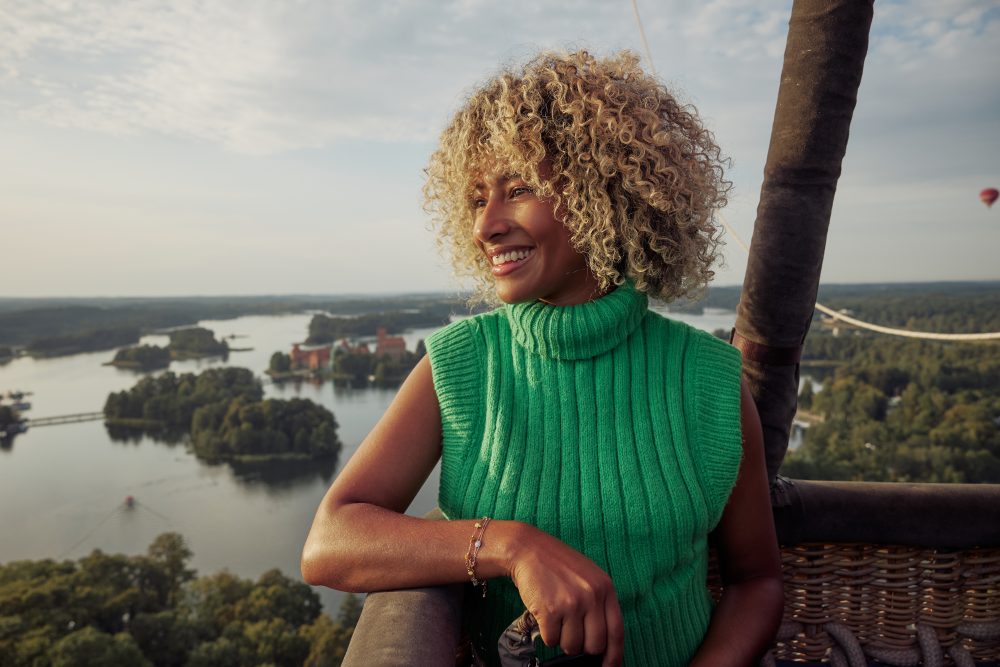 Traveler enjoying a hot air balloon ride near Vilnius, with stunning views all around.